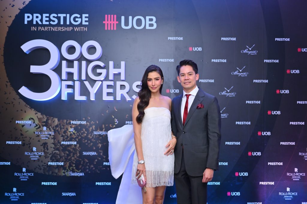 Sririta Jensen Narongdej and Korn Narongdej pose with 300 High Flyers main backdrop