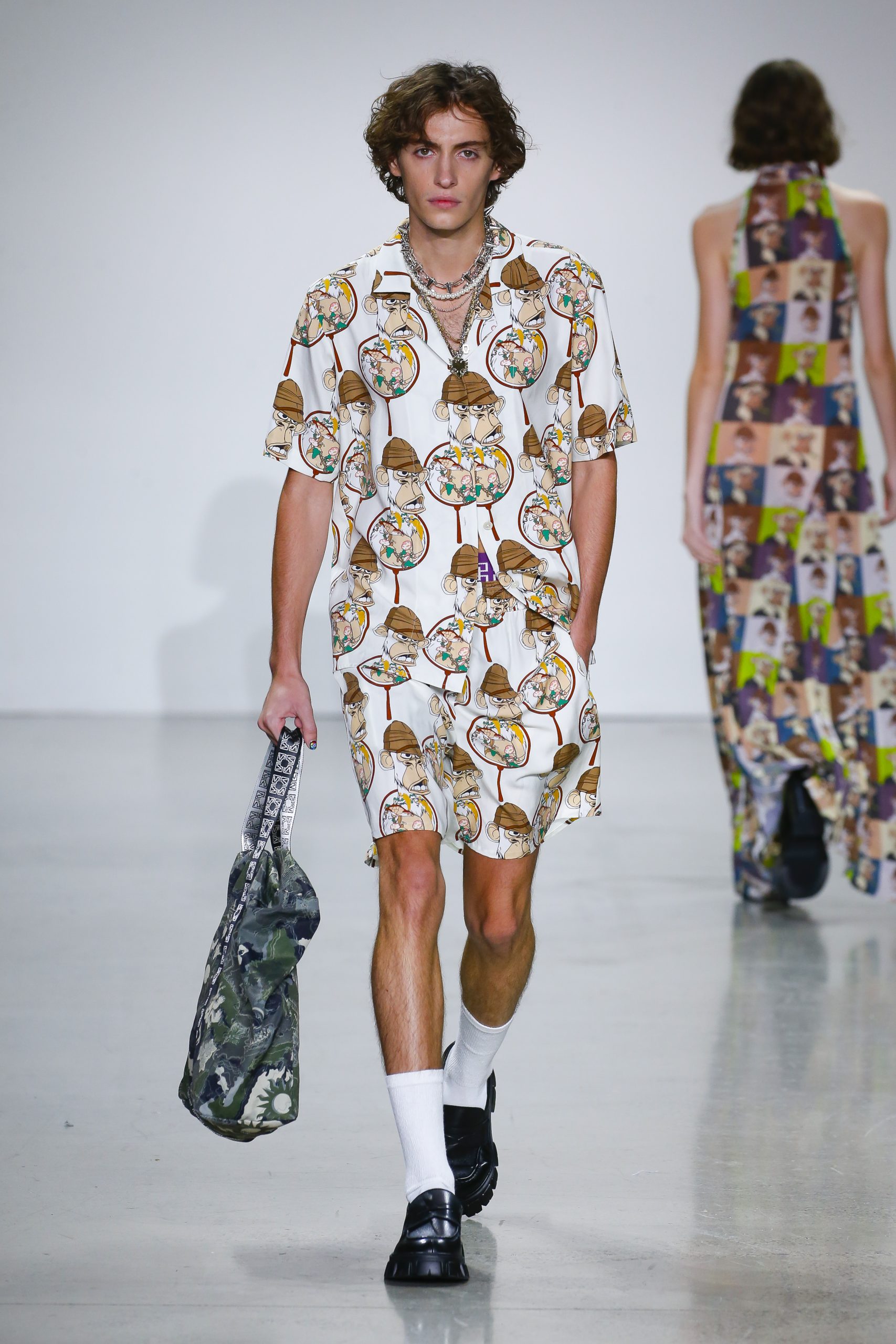 Male model wearing white garments from NFT collection at Vivienne Tam’s Metaverse, Past, Present, and Future SS23 show at New York Fashion Week