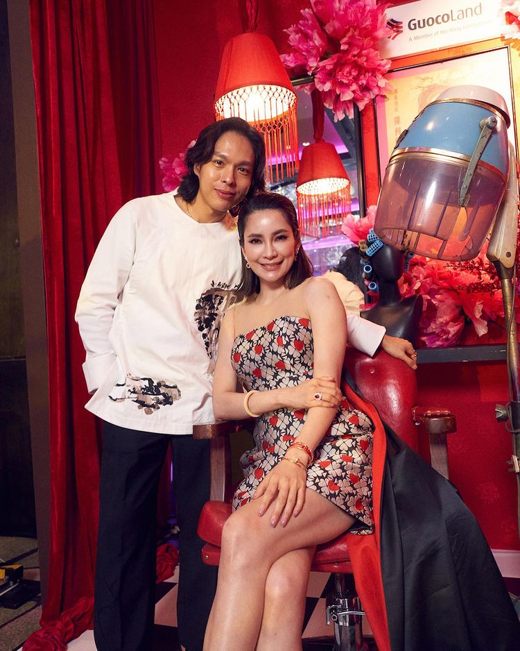 Guests pose with the GuocoLand Hair Salon backdrop at PINCNY2023 event