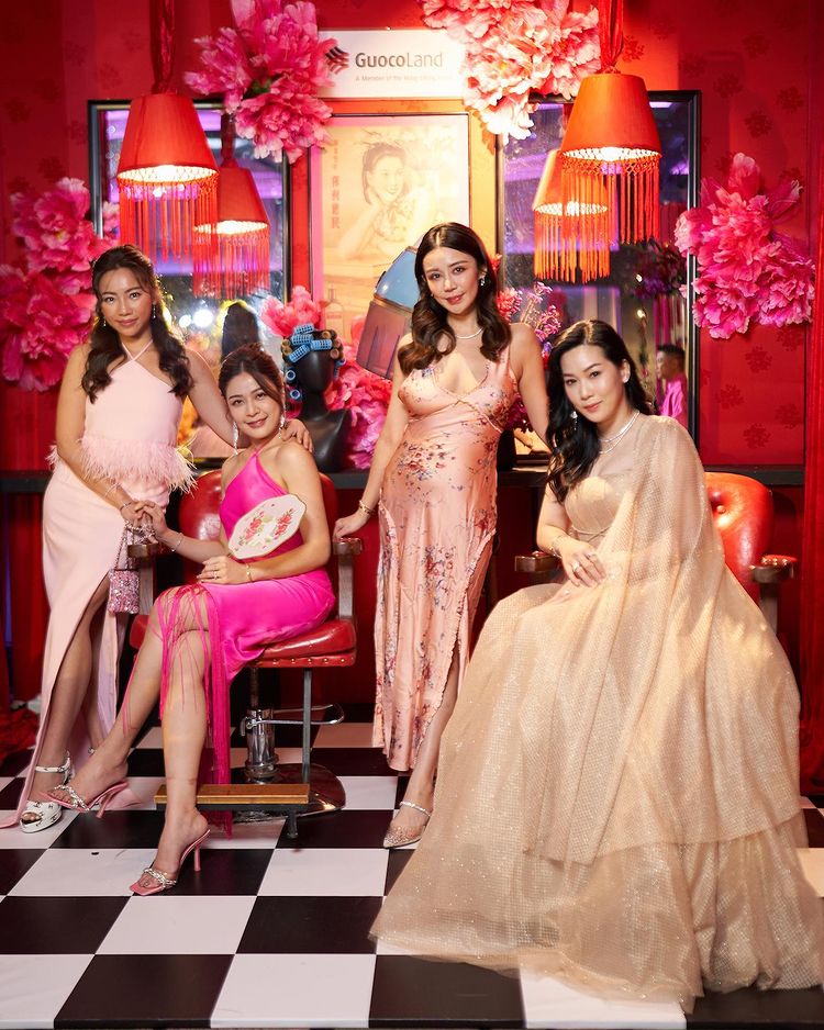 Guests pose with the GuocoLand Hair Salon backdrop at PINCNY2023 event